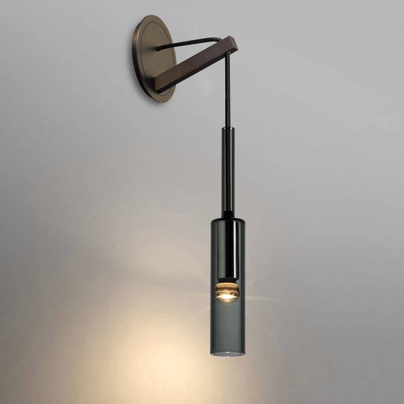 Sanna wall light with round backplate and angled arm on a plain wall