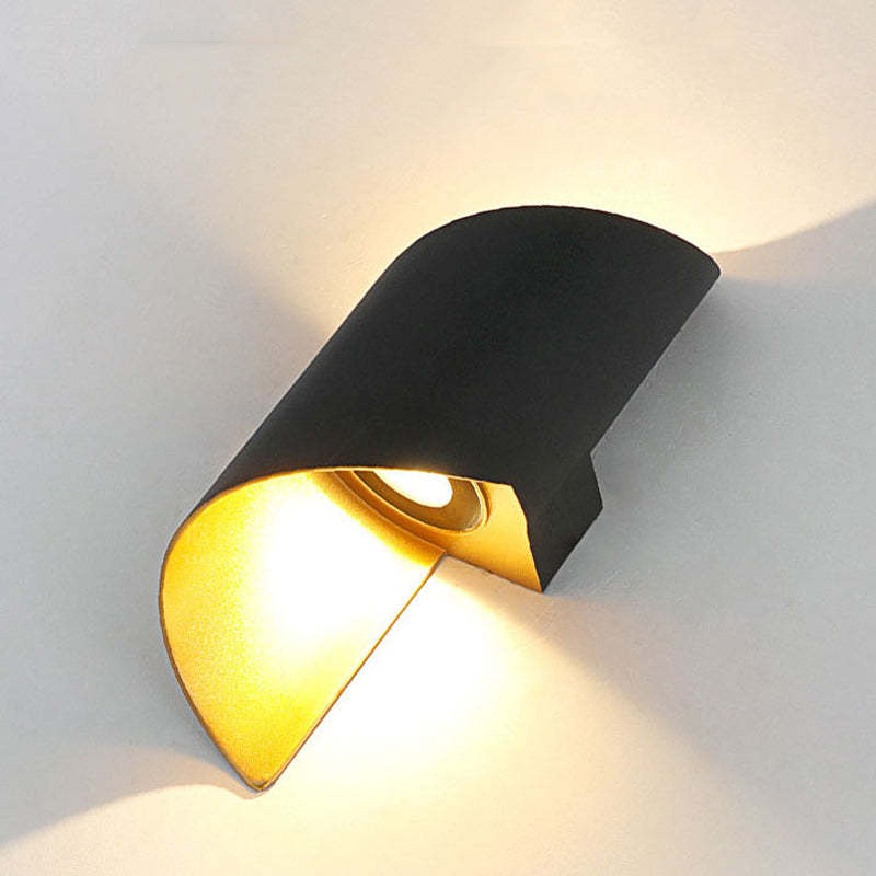 Low-angle close-up of a black and gold lower opening, luminous insert and surrounding wall glow