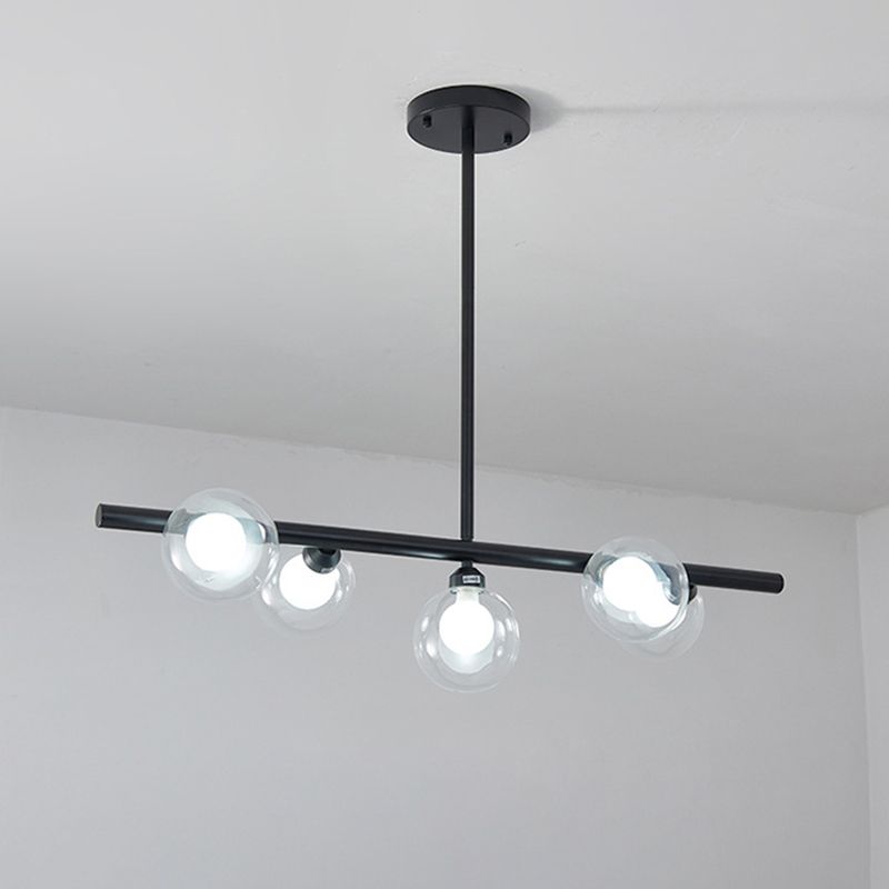 Black five-globe pendant at an oblique angle, showing clear outer glass and bright inner forms
