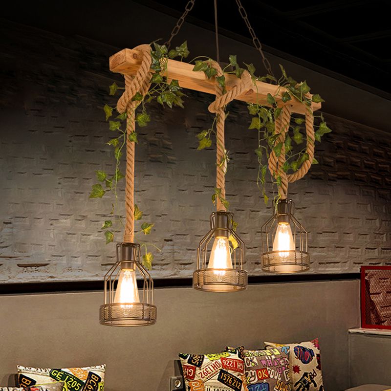 Three illuminated cage lamps on a wood beam above a sofa, with leafy decoration.