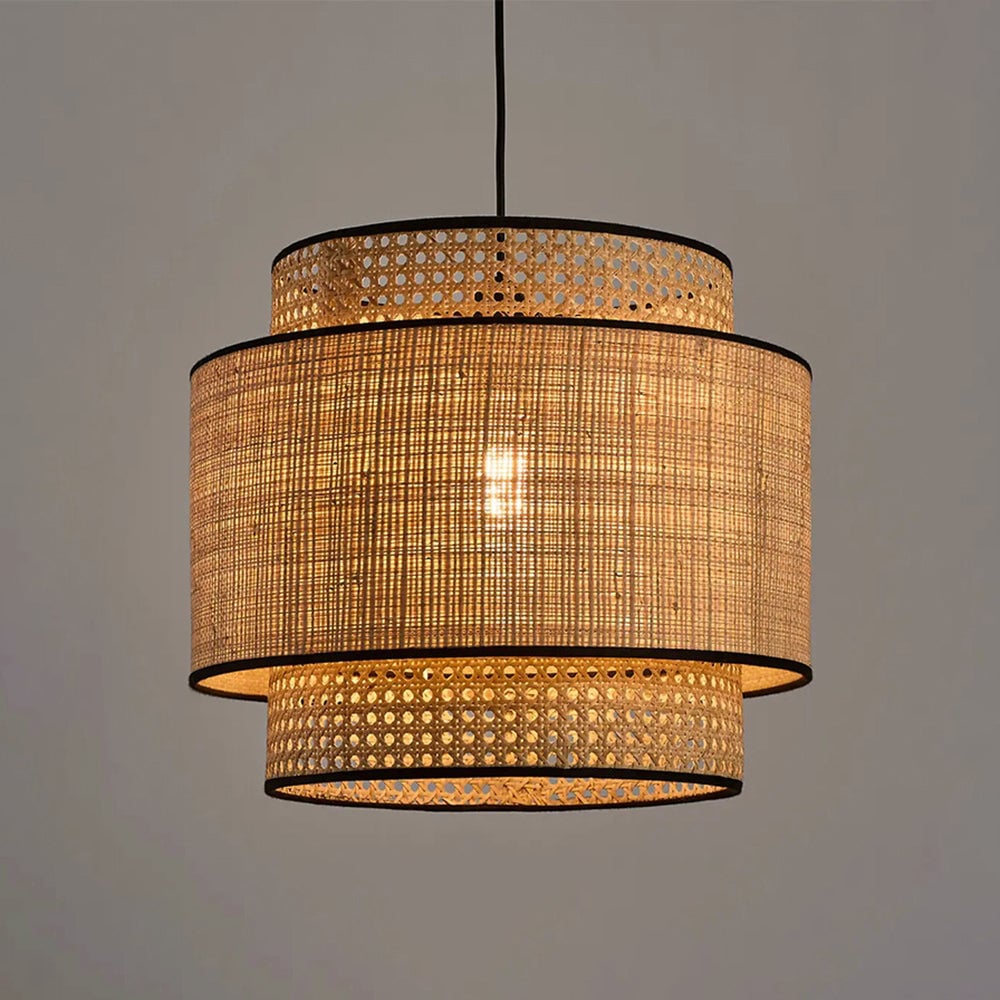 Illuminated layered rattan shade with a visible warm bulb