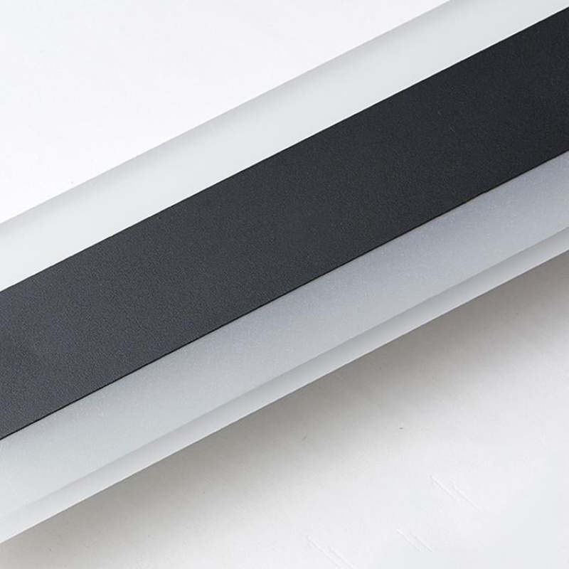 Diagonal close-up of the textured dark center and pale surround of an Edge wall light