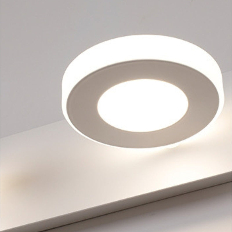 Close view of a round light face on the Leigh wall lamp