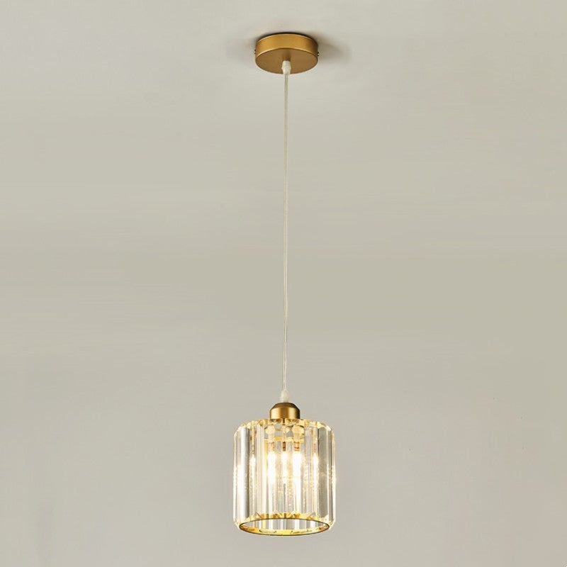 Isolated single cylindrical glass-bar shade with gold frame, small round gold canopy and pale suspension cord