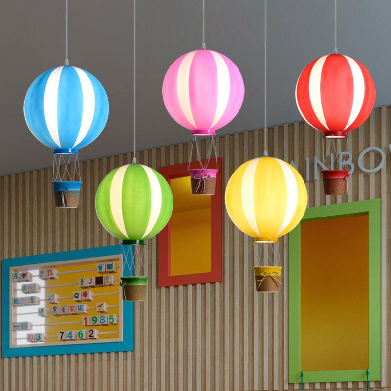 Blue, pink, red, green and yellow E-type balloon pendant lights with hanging baskets displayed in a room