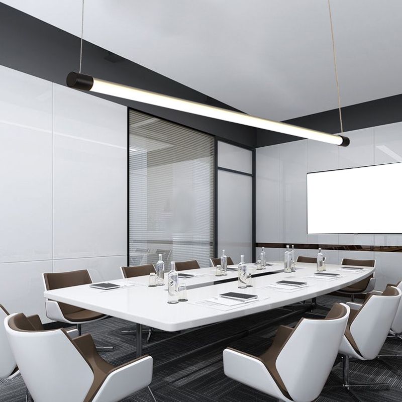 Black-endcap linear pendant above a meeting table with bottles, notebooks and a wall screen