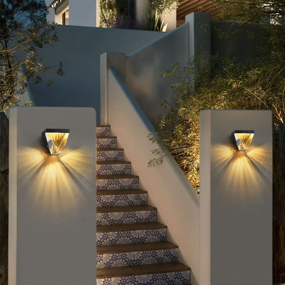 Two separate Orr wall lamps casting warm rays beside outdoor steps