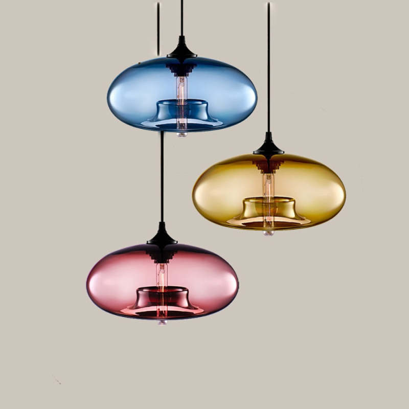 Separate Blue, Amber and Pink oval glass pendants at staggered heights against a light Beige background