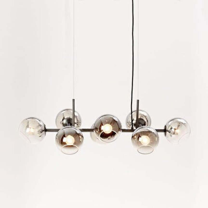 Dark-frame Valentina pendant with reflective glass globes and lit bulbs on a pale background