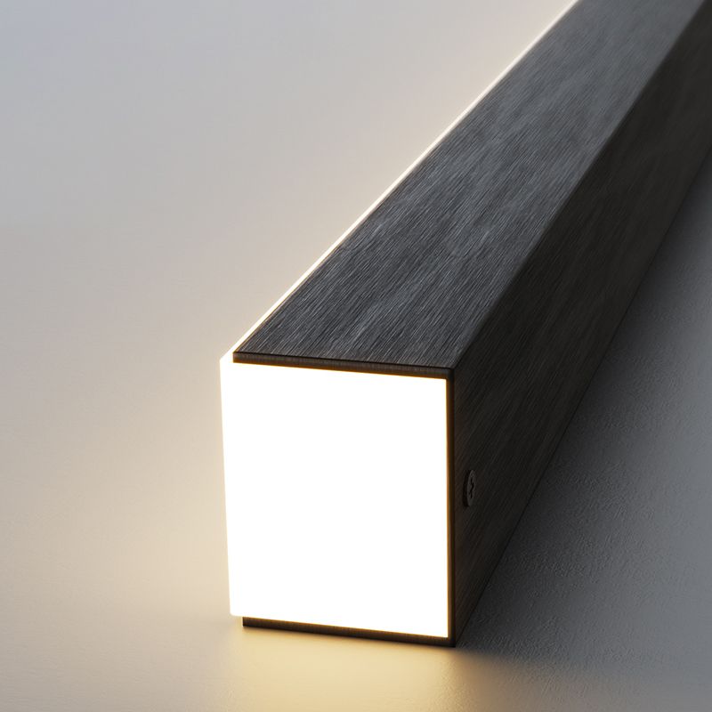 Close view of black Edge bar end with glowing white face, brushed-look housing and side screw