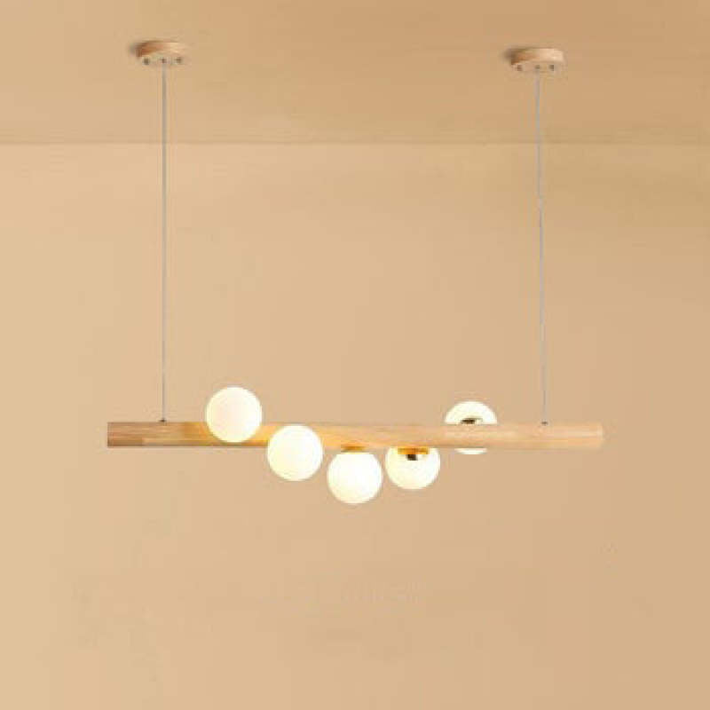 Light wooden bar pendant with five warm-looking globes, two cables and round canopies against a Beige background