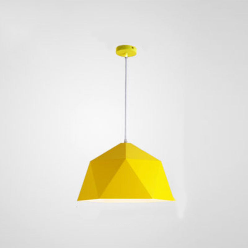 Yellow faceted pendant light with a pale cord and matching yellow ceiling canopy