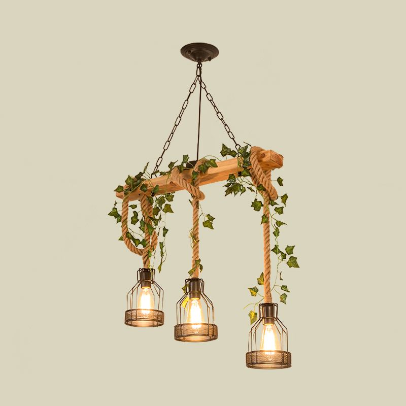 Three-light wood-beam pendant with cage shades, looped cords and leafy decoration.