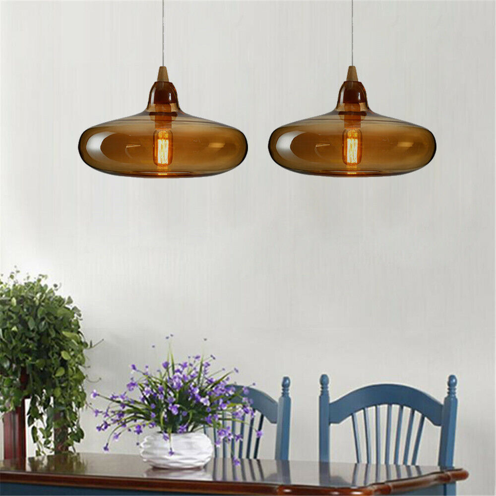 Two broad Hailie amber pendants above a dining table with flowers