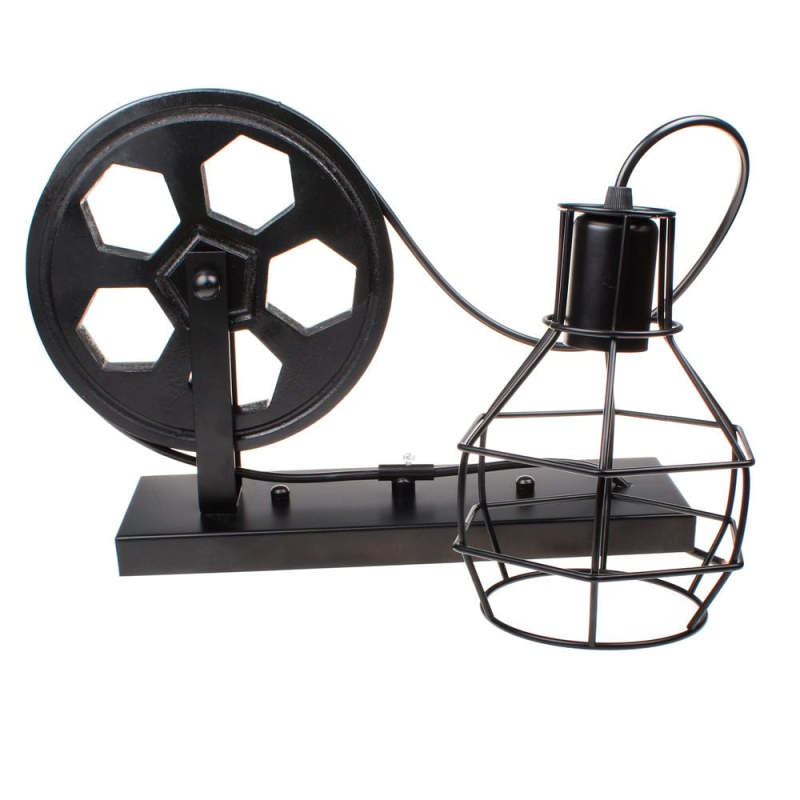 Black Alessio fixture laid on white with cable around the wheel and cage resting sideways