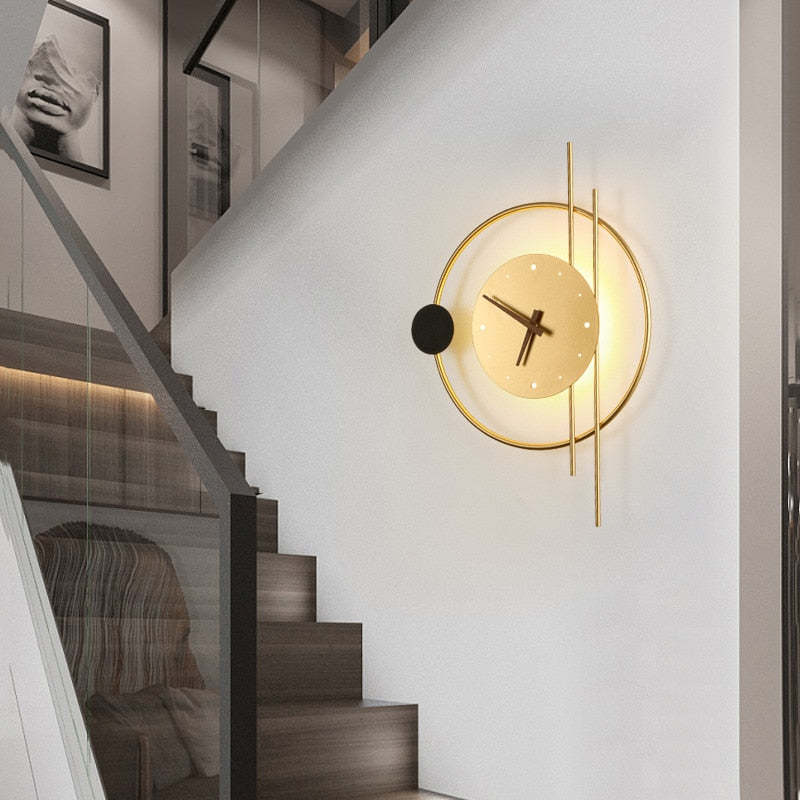Illuminated gold clock light mounted beside stairs