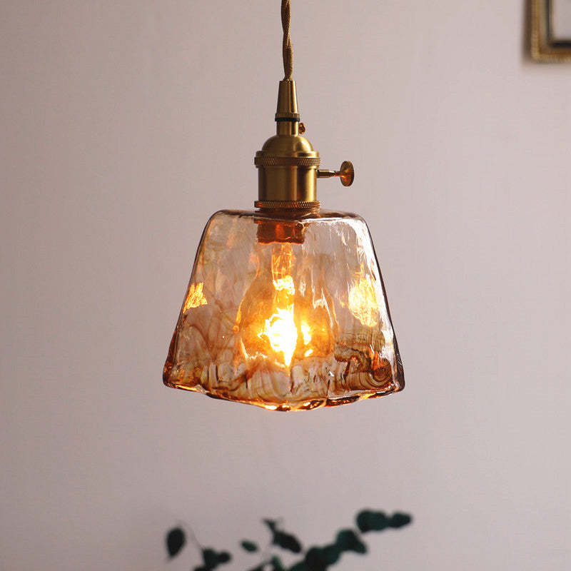 Tapered textured amber glass pendant with a wavy lower rim and a side knob