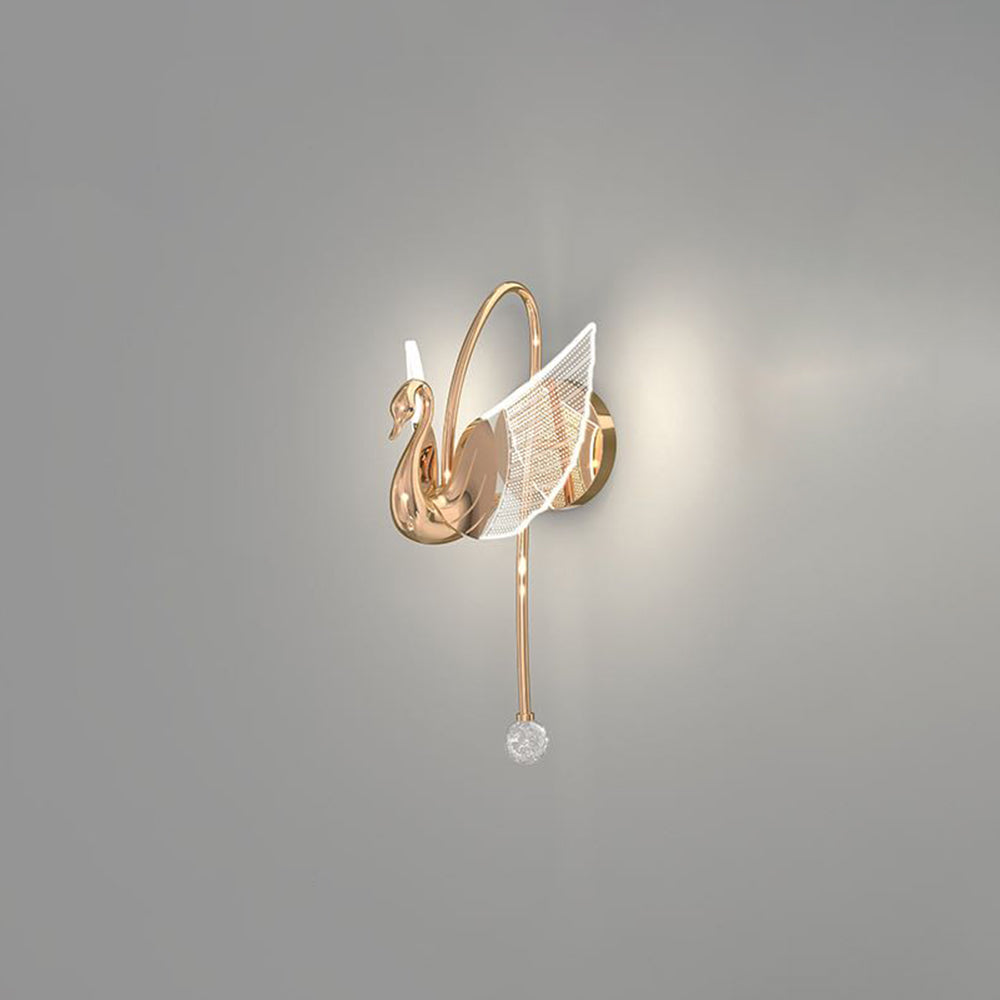 Rose Gold swan wall light on a pale wall, with an arch, round backplate, patterned wings and a stem with a ball