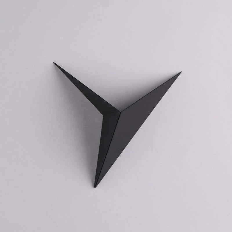 Black Orr folded triangular wall lamp on a plain wall