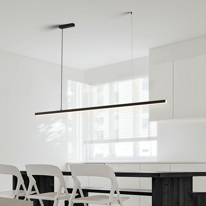 Black Edge linear pendant with glowing underside above dining table and white chairs beside window blinds
