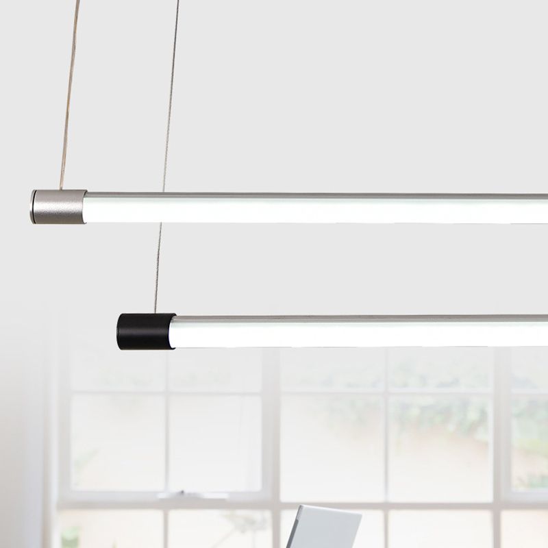 Close comparison of silver and black cylindrical end fittings on slim luminous tubes