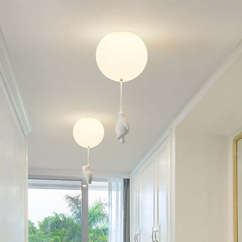 Two bear balloon ceiling lights along a hall near a window