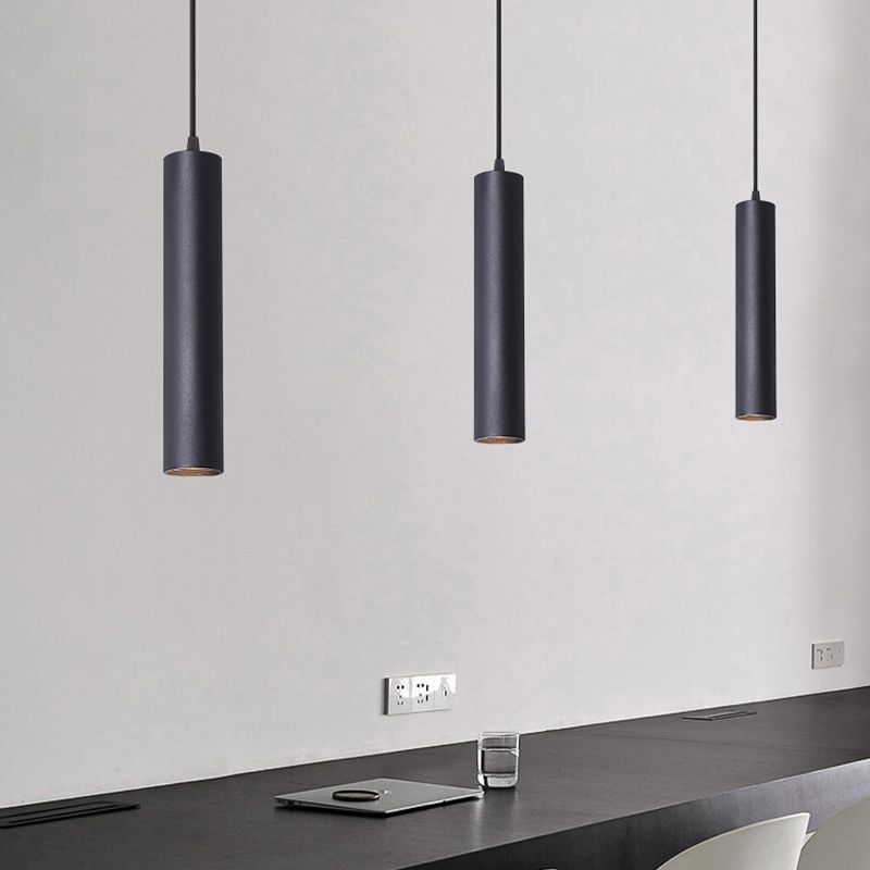 Three black Edge pendants above a dark countertop.