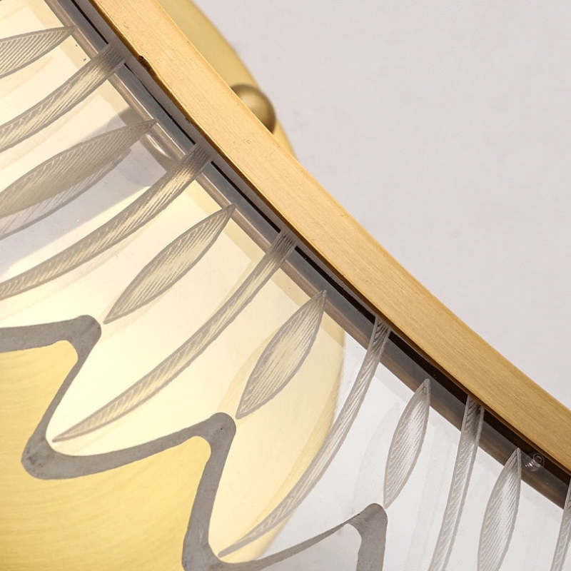 Angled detail of Kristy feather-outline pieces attached along a gold-tone strip