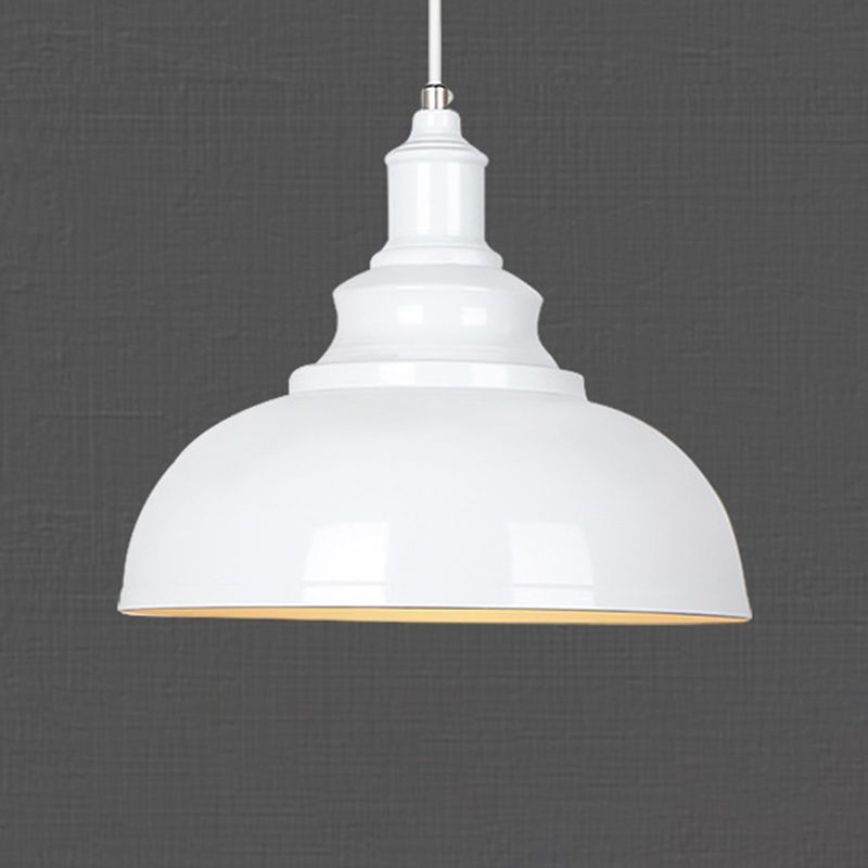 Close view of white domed metal shade and stepped top