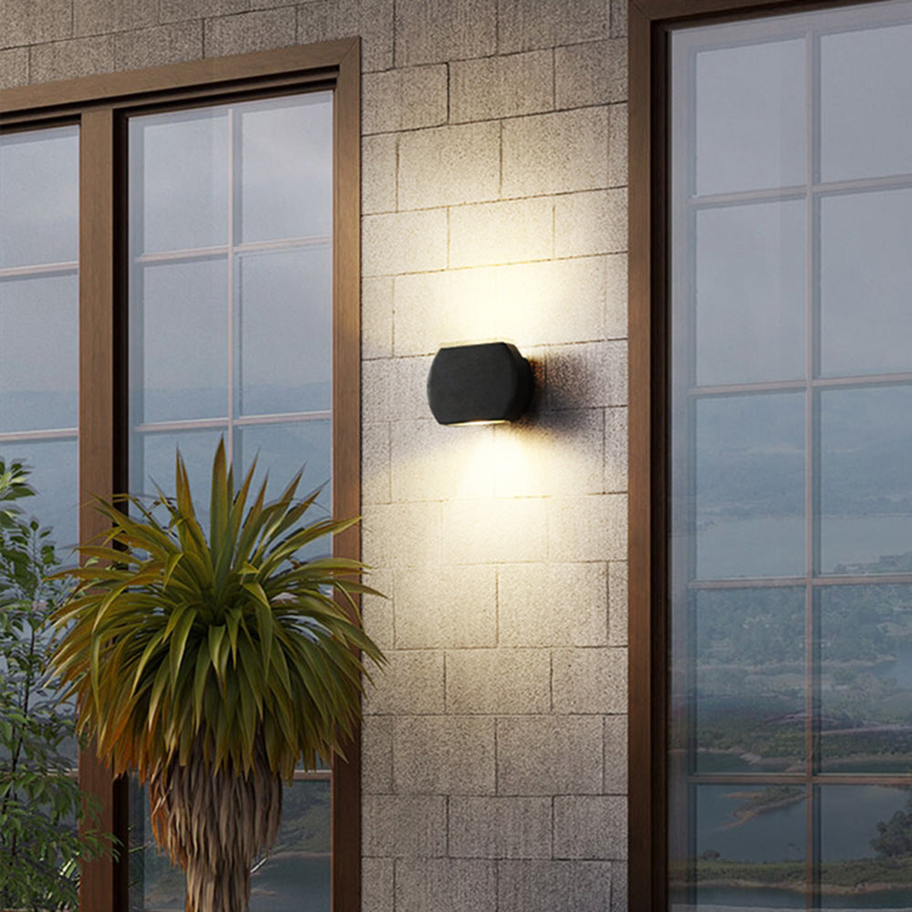 Gray Style A Orr light on an exterior brick wall between tall windows