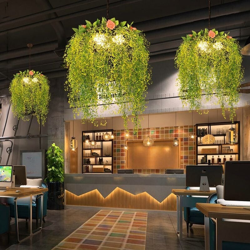 Several illuminated foliage-style pendants in a restaurant