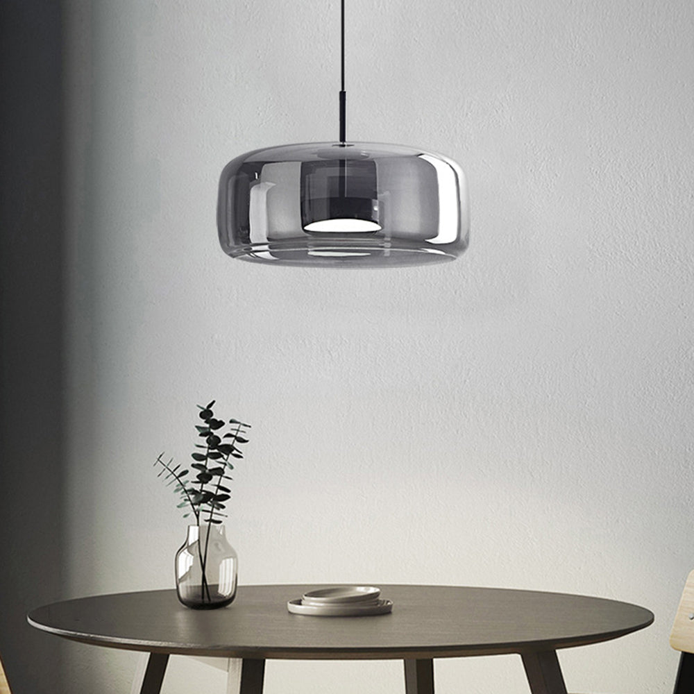 Wide smoke-grey Hailie pendant with black inner fitting above round dining table with vase and plates