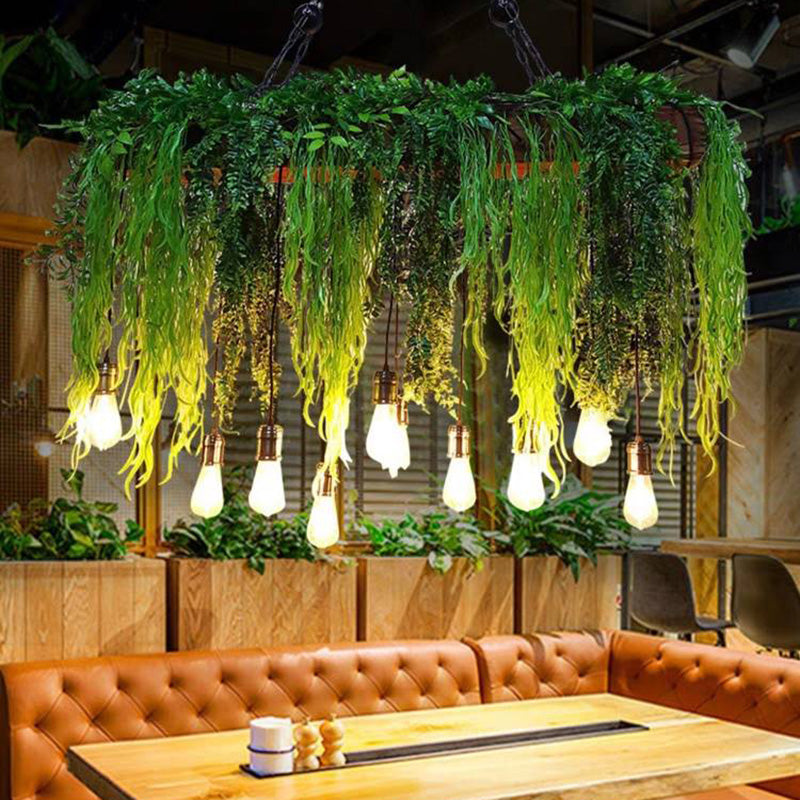 Nest greenery pendant above a restaurant table with upholstered bench seating.