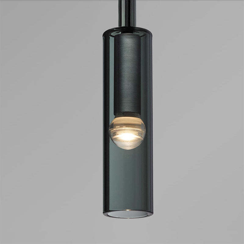 Close view of Sanna black cylindrical shade and lit bulb-shaped element