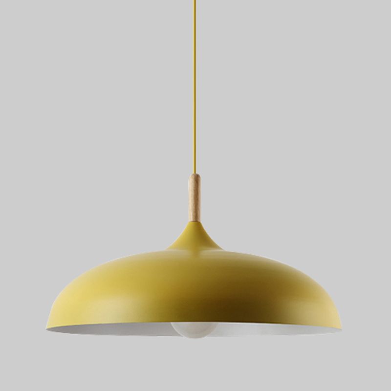 Yellow shallow dome pendant with a matching cord and contrasting wood-toned upper collar