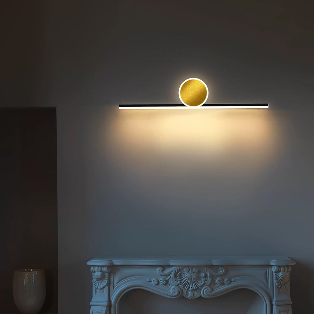 Emyr horizontal bar and disc casting light down the wall above a decorative fireplace