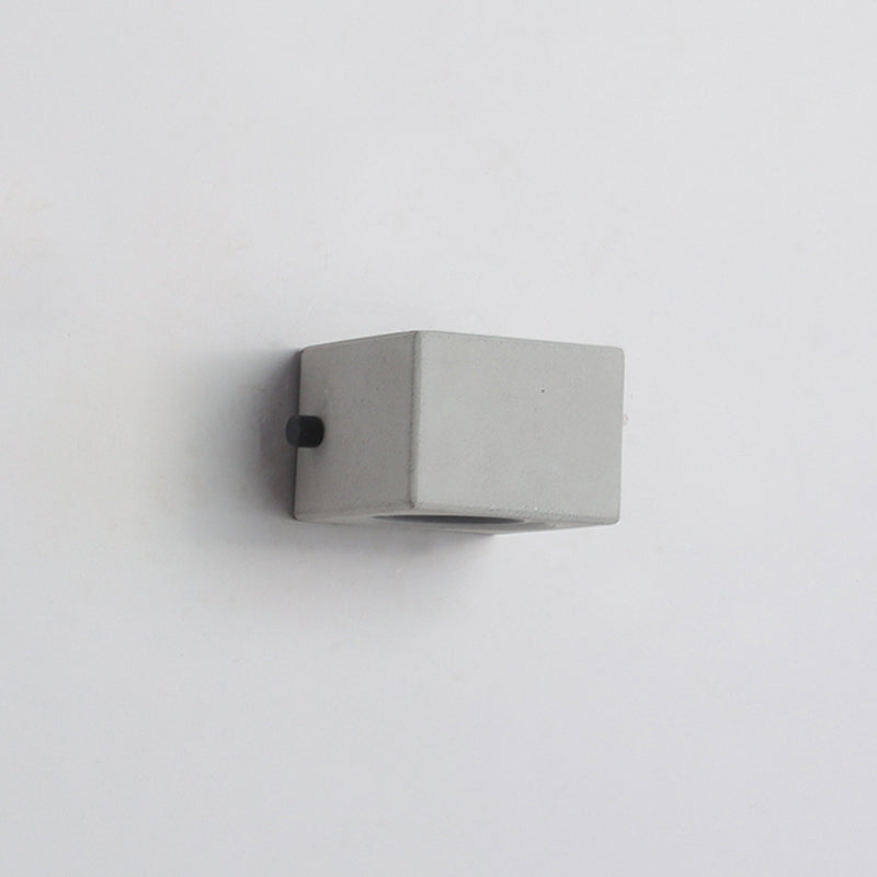 Short unlit cement wall block seen from an angle