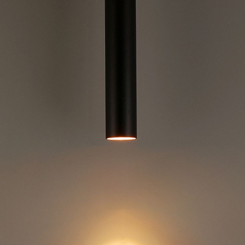 Close-up of a black Edge pendant casting warm light downward.