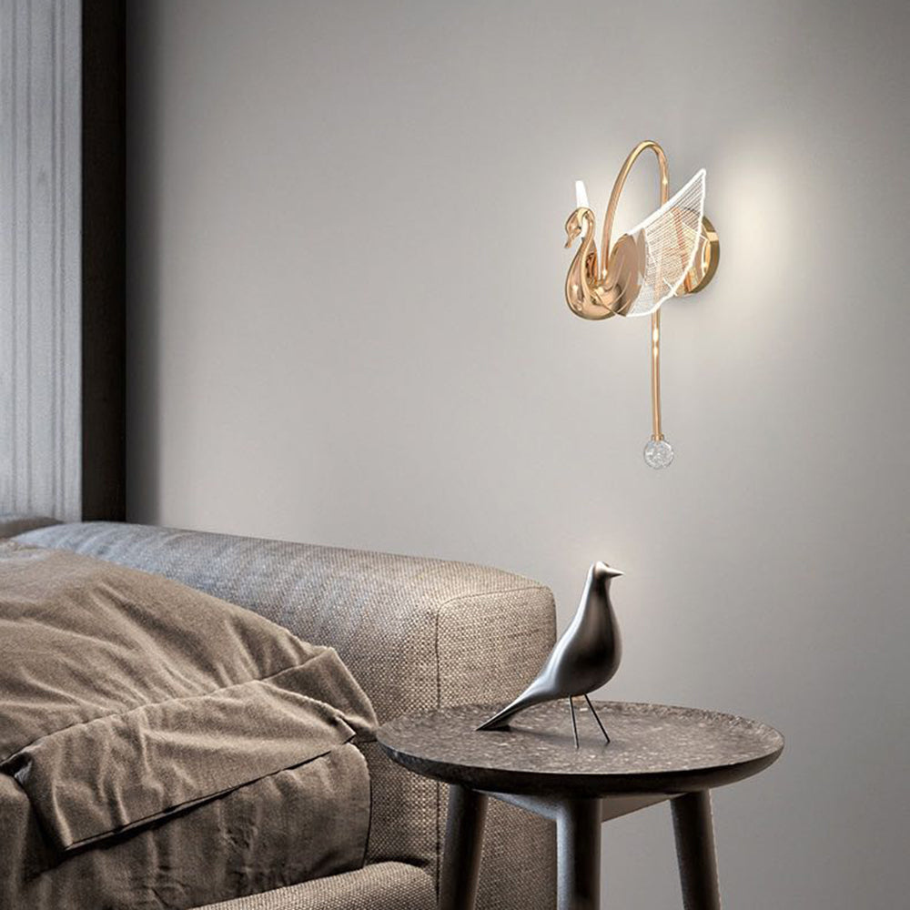 Kady Gold swan wall light above a sofa and round table carrying a black bird ornament
