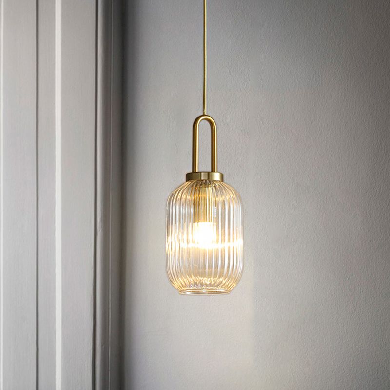 Narrow cylindrical Sanna A pendant on a gold-toned suspension rod