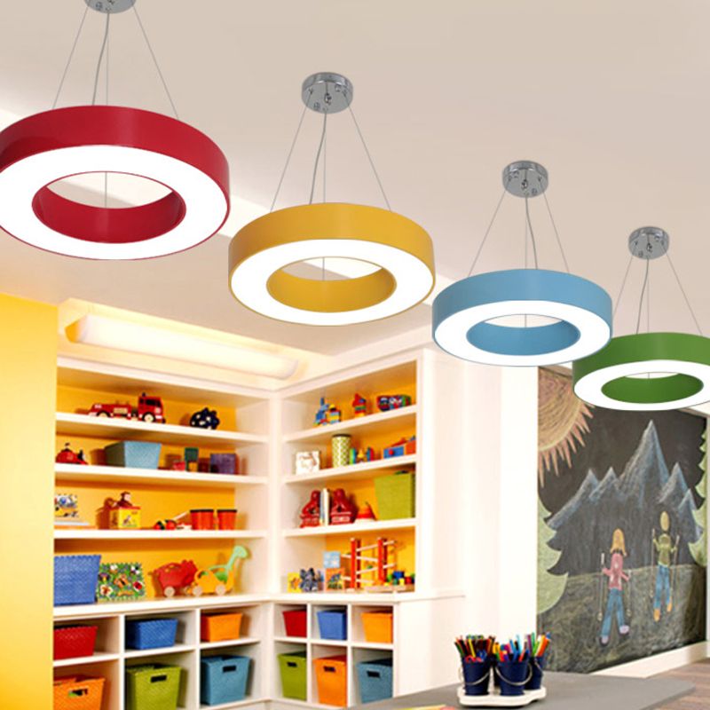 Four separate red, yellow, blue and green rings above toy shelves, storage boxes, desk and chalkboard