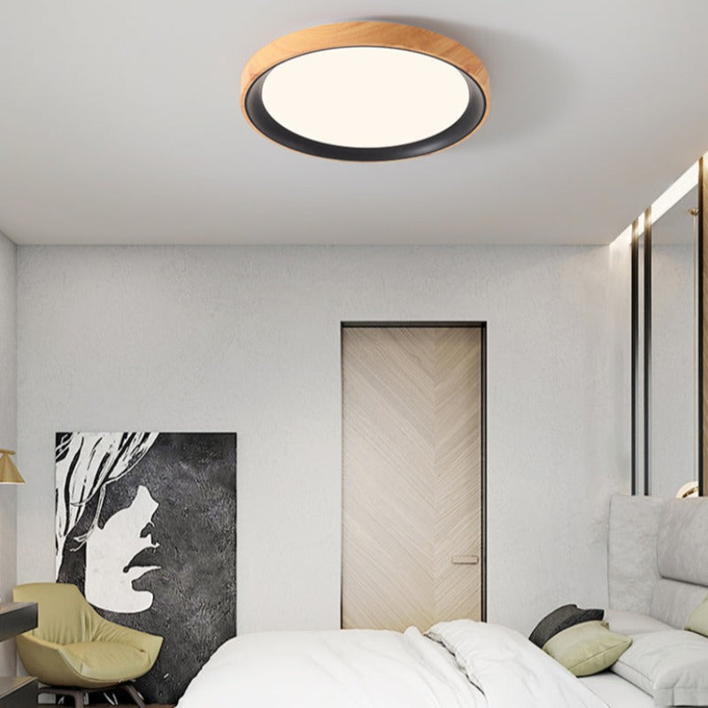 Quinn light wood-tone ring and dark trim above a bed
