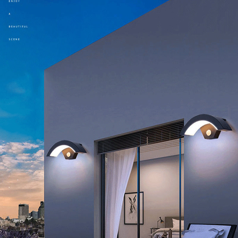 Black arc wall lamps beside an exterior doorway