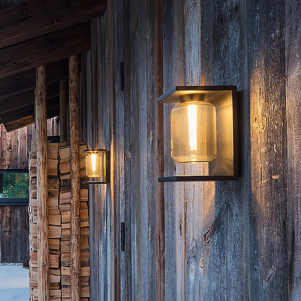 Warm-lit Orr wall lanterns mounted on a timber exterior wall.