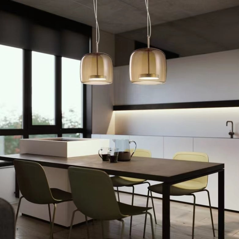 Two compact Smoke Gray Hailie pendants above a dining table