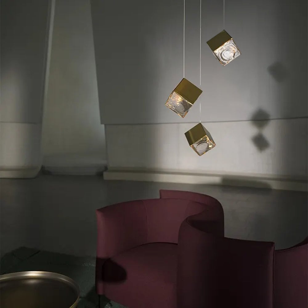 Three glass cube lights above dark lounge seating