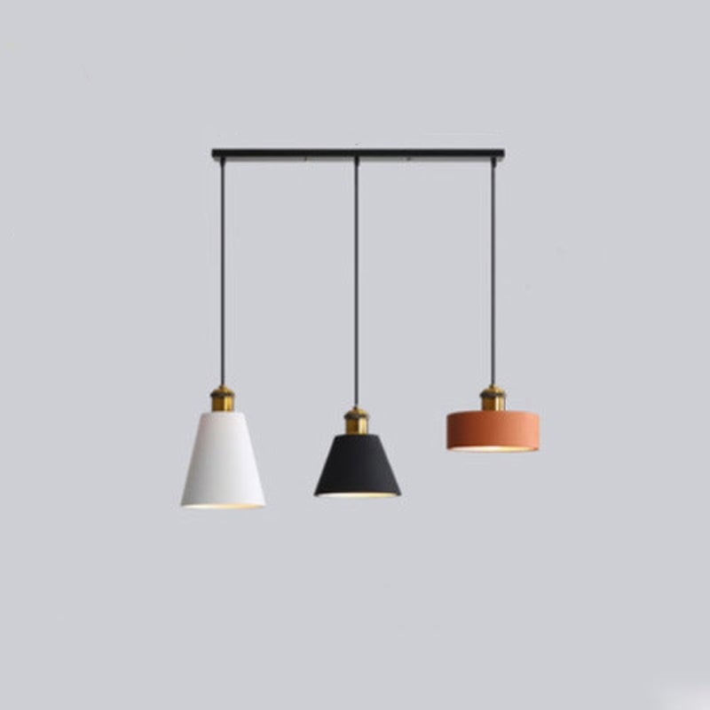 Morandi three-head pendant on a long ceiling bar with white, black and orange shades.