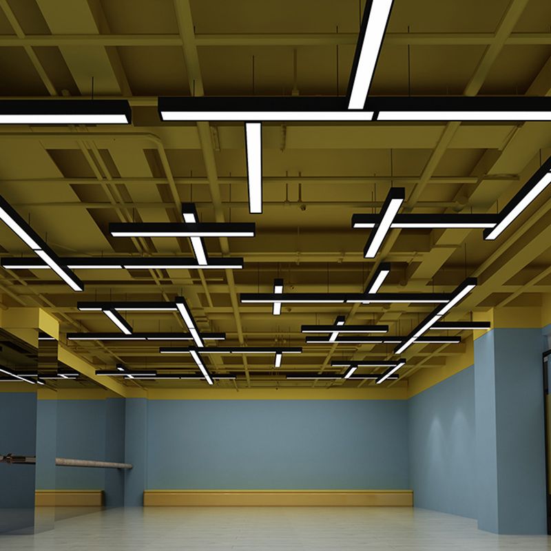Rows of linear pendant lights below an exposed ceiling