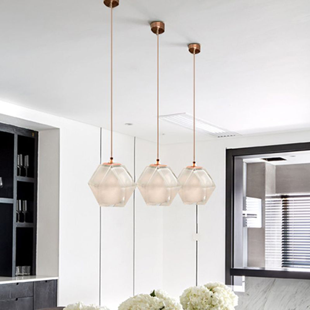 Three white Hailie glass pendants pictured in a dining area