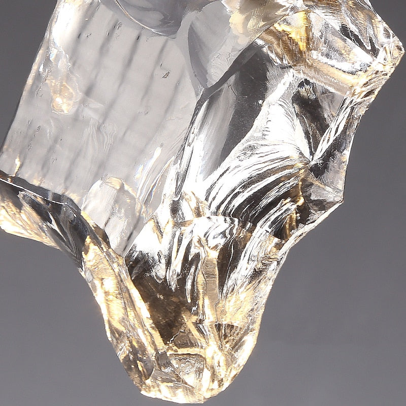 Close view of the clear irregular crystal surface and illuminated lower edges.